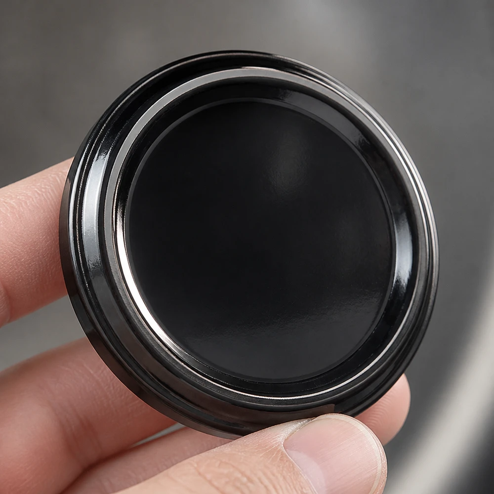 UNiTWIST TO48 černý BioSeal BPA-NI – detailní záběr lesklého povrchu černého víčka typu „twist-off“ o průměru 48 mm