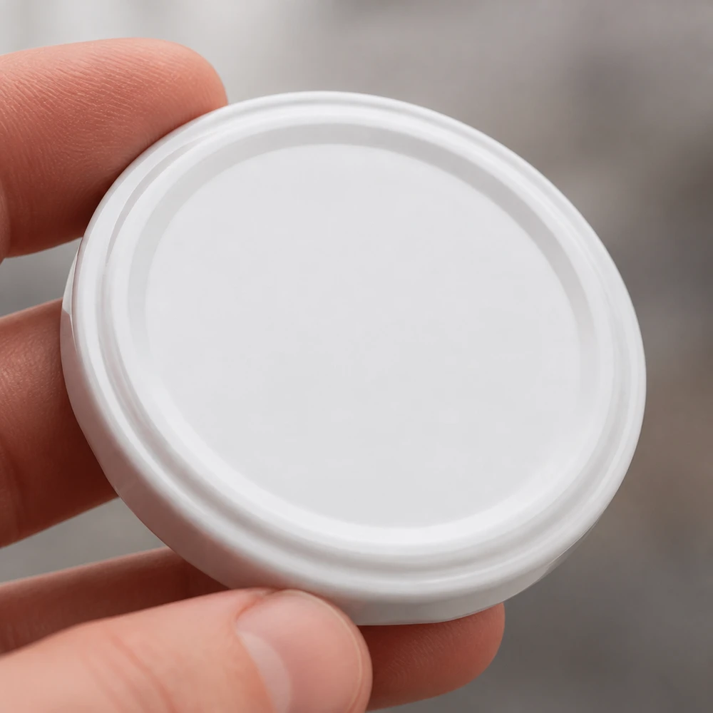 63mm víko BioSeal bílé (TO63) UNiTWIST Detailní záběr bílého víčka UNiTWIST TO63 typu „twist-off“ BioSeal BPA-NI unitemp, kulatého tvaru